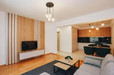a living room with a couch and a tv at Status-M Apartments 134 in Becici