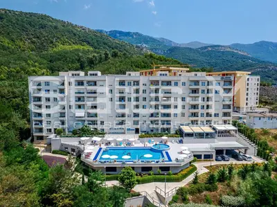 an apartment building with a swimming pool and a resort at Status-M Apartments 134 in Becici