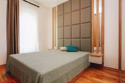a bedroom with a bed with a green pillow on it at Status-M Apartments 134 in Becici