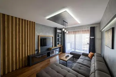 a living room with a couch and a television at Apartments 28 Master Quart in Podgorica