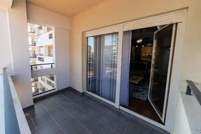 a balcony with sliding glass doors in a apartment at Apartments 28 Master Quart in Podgorica