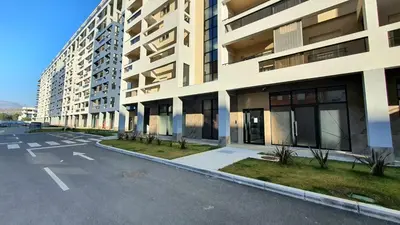 an empty parking lot next to a tall building at Apartments 28 Master Quart in Podgorica