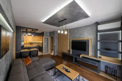 a living room with a couch and a tv at Apartments 28 Master Quart in Podgorica