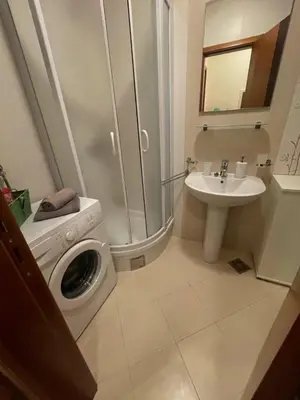 a bathroom with a washing machine and a sink at Exclusive studio, great location in Podgorica
