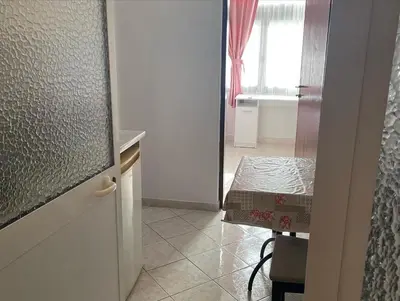 a room with a kitchen with a table and a window at Apartments Plaza in Ulcinj