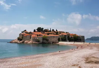 a house on a island in the water on a beach at Lovely Apartment Sveti Stefan in Sveti Stefan