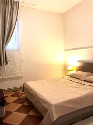 a bedroom with a large bed and a window at Lovely Apartment Sveti Stefan in Sveti Stefan