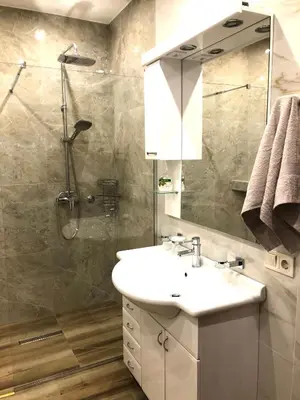 a bathroom with a sink and a shower at Lovely Apartment Sveti Stefan in Sveti Stefan