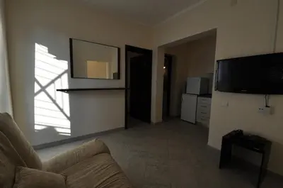 a living room with a couch and a flat screen tv at Rafailovici Holiday Apartments in Rafailovici