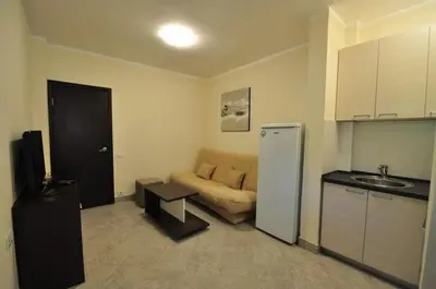 a living room with a couch and a refrigerator at Rafailovici Holiday Apartments in Rafailovici