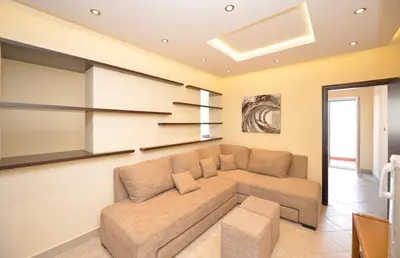 a living room with a couch and a table at Rafailovici Holiday Apartments in Rafailovici