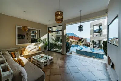 a living room with a couch and a pool at The Dream Getaway & Spa by DeVasco in Becici