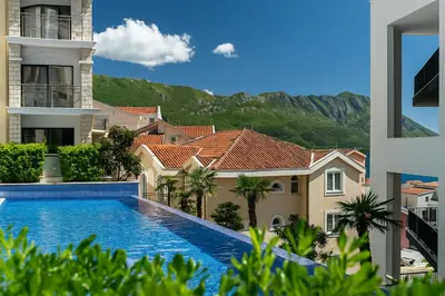 a view from the balcony of a building with a swimming pool at The Dream Getaway & Spa by DeVasco in Becici