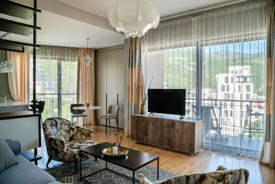 a living room with a couch and a tv at The Dream Getaway & Spa by DeVasco in Becici