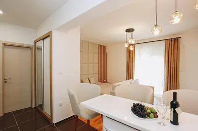 a kitchen and living room with a table and chairs at Status-M Apartments 135 in Becici