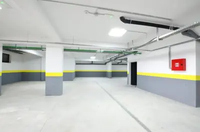 an empty parking garage with yellow and white walls at Horizon Two bedroom Apartment with sea view Jake in Becici
