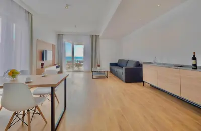 a living room with a table and a couch at Horizon Two bedroom Apartment with sea view Jake in Becici