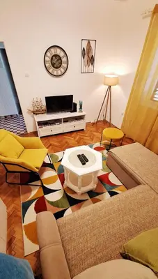 a living room with a couch and a table at Red House Apartment in Kotor