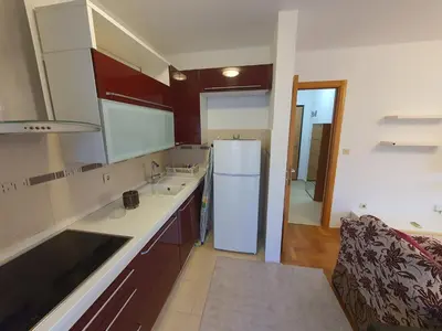 a kitchen with a white refrigerator and a sink at Comfort one bedroom apartment in Podgorica