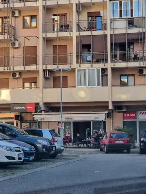 a parking lot with cars parked in front of a building at Comfort one bedroom apartment in Podgorica