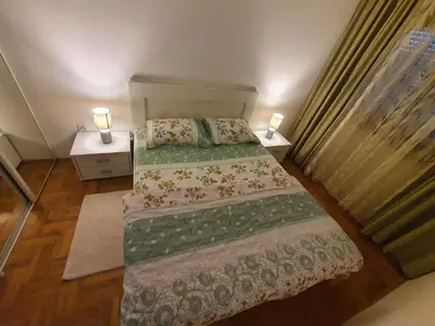 a small bedroom with two beds and two lamps at Comfort one bedroom apartment in Podgorica
