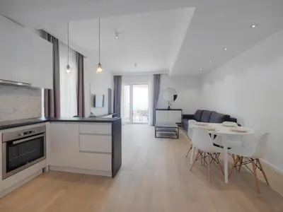 a kitchen and living room with a table and chairs at Horizon-Two Bedroom Apartment Partial Sea View Charlene in Becici