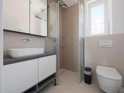 a bathroom with a toilet and a sink and a shower at Horizon-Two Bedroom Apartment Partial Sea View Charlene in Becici