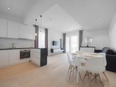 a kitchen and living room with a table and chairs at Horizon-Two Bedroom Apartment Partial Sea View Charlene in Becici