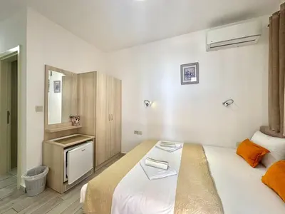 a hotel room with a bed and a mirror at Villa Ines in Budva