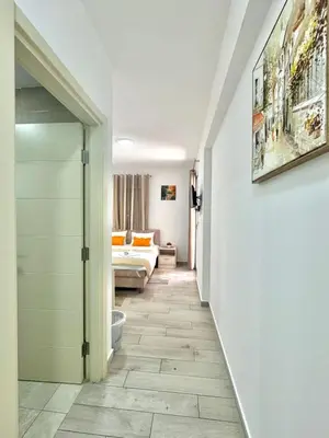 a hallway with a room with a bed and a door at Villa Ines in Budva
