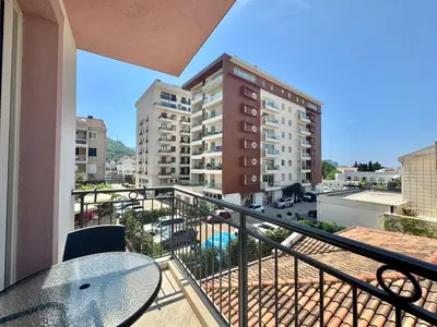 a balcony with a table and a view of a building at Villa Ines in Budva