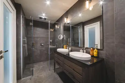 a bathroom with two sinks and a shower at SIGNUM Hotel in Podgorica