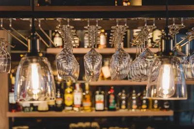 a group of glass vases on a shelf with bottles at SIGNUM Hotel in Podgorica