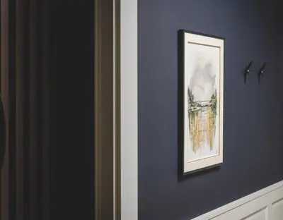 a picture on a blue wall with a picture on it at SIGNUM Hotel in Podgorica