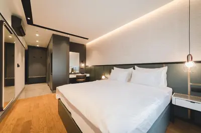 a bedroom with a large white bed in a room at SIGNUM Hotel in Podgorica