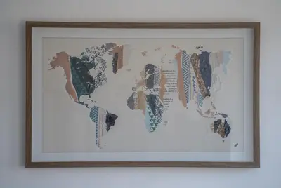 a framed map of the world on a wall at Apartman J&I in Kotor