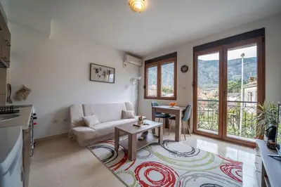 a living room with a couch and a table at Apartman J&I in Kotor