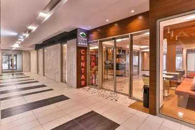 a store hallway with glass doors and a store front at Carine Hotel Centar in Podgorica