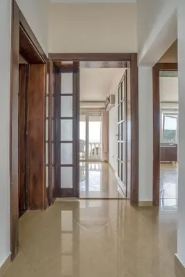 an open hallway with sliding glass doors and a floorplan at Apartman -PANORAMA LUX in Sutomore