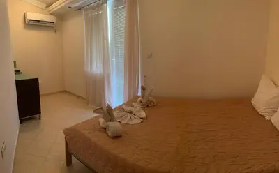 a bedroom with a bed with two stuffed animals on it at Apartman -PANORAMA LUX in Sutomore