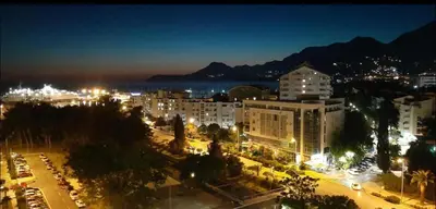 a city lit up at night with buildings and street lights at M & A Apartment Bar A 29 in Bar