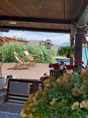 a patio with a bunch of flowers and a chair at Zen House for 2 in Ulcinj