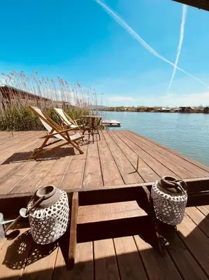a dock with two vases and a chair on the water at Zen House for 2 in Ulcinj