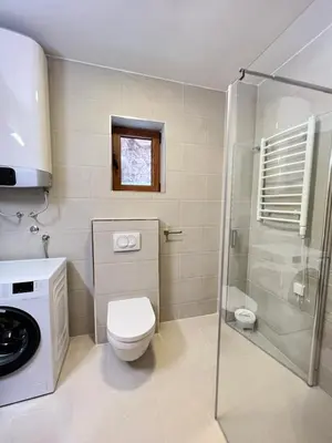 a bathroom with a toilet and a glass shower at Varja 3 Apartment in Pržno
