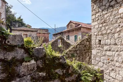 a group of stone buildings in a city at Old Town Terrace Vibe in Kotor