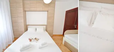 a bedroom with two beds and a table with a book at Sofija Apartment in Kotor
