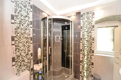 a shower with a glass door in a bathroom at Sofija Apartment in Kotor