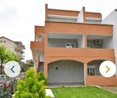 a building with two arrows in front of it at Apartmani Maša in Budva