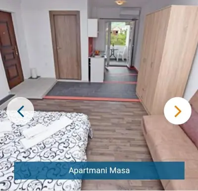 a bedroom with a bed and an open hallway at Apartmani Maša in Budva