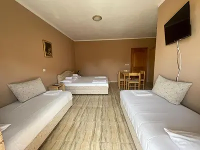 a hotel room with two beds and a flat screen tv at Mali Medved Ulcinj in Ulcinj